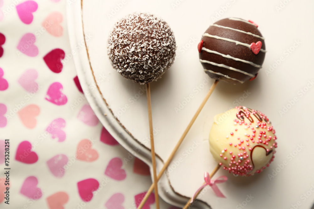 Tasty cake pops on plate, close up Tasty cake pops on plate, close up