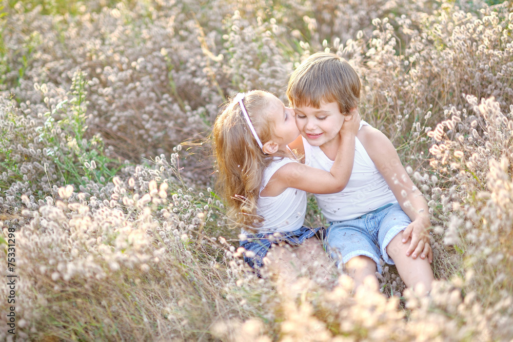 Portrait of a boy and girl on the field in summer Portrait of a boy and girl on the field in summer