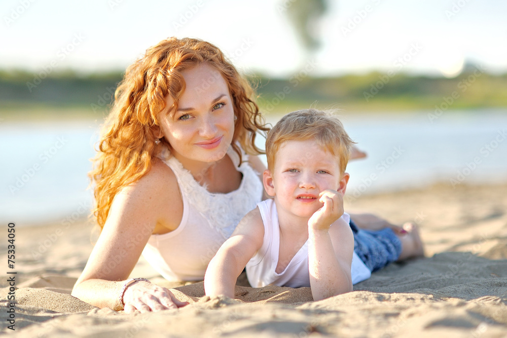 Happy Mom and baby son in summer nature