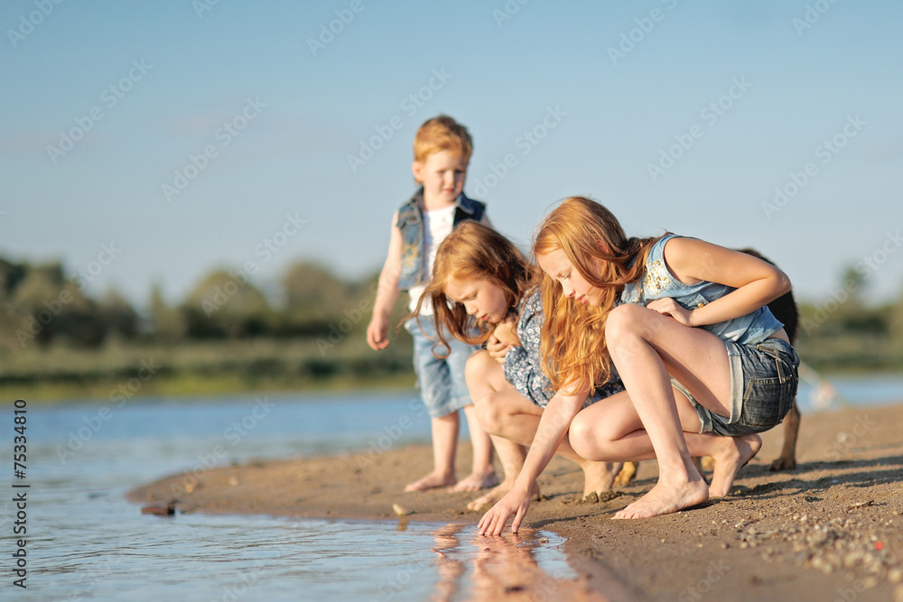 Fototapeta premium Portrait of a boy and his two sisters loved