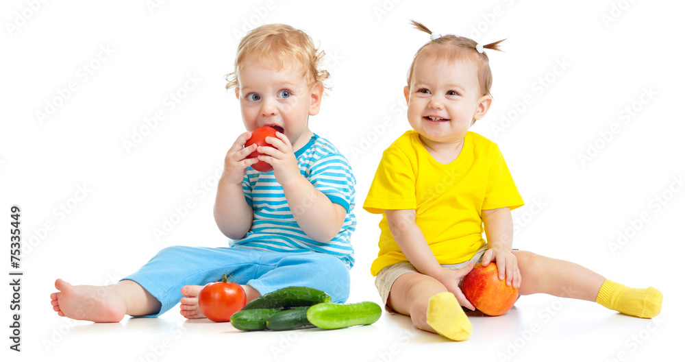 Kids eating fruits and vegetables isolated Kids eating fruits and vegetables isolated