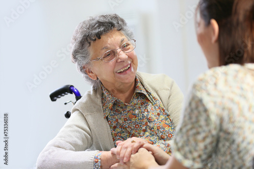 Elderly woman sharing good time with home carer