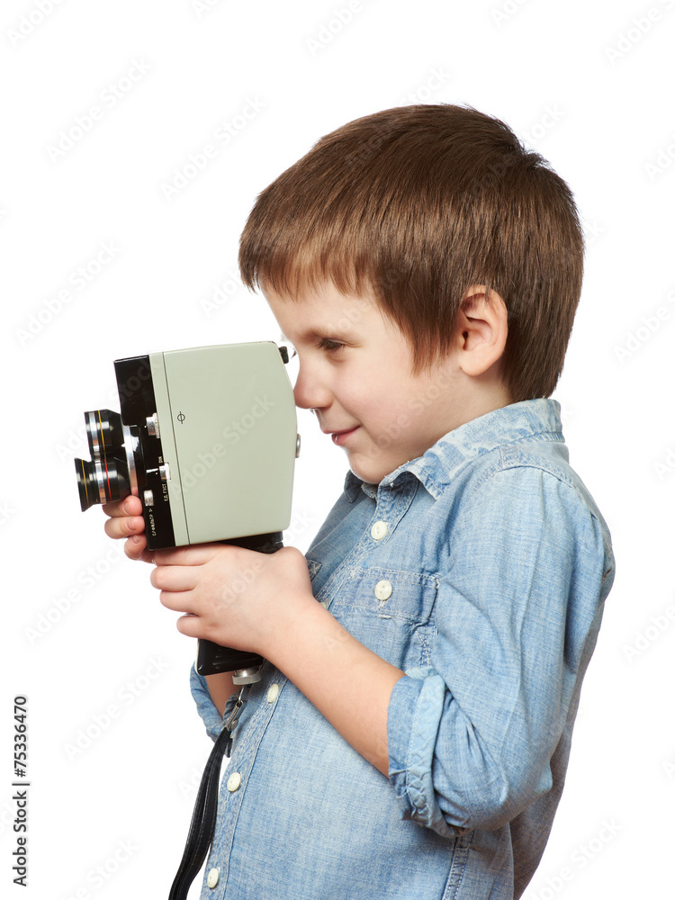 Little boy cameraman filming with retro camera Little boy cameraman filming with retro camera