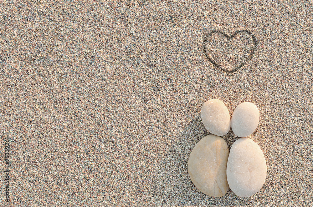 Pebbles shapes lovers with heart on the sand Pebbles shapes lovers with heart on the sand