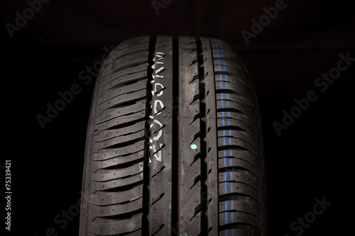 Car tires close-up on black background