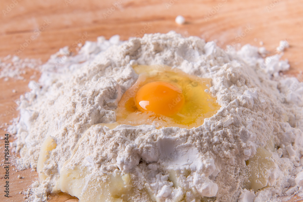 Flour and egg dough preparation on dough board Flour and egg dough preparation on dough board