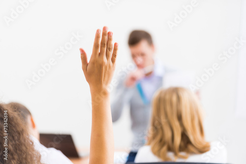 female hand raised in class