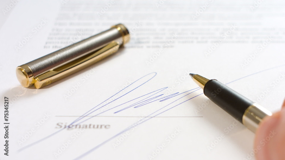 Man writing signature and pen Man writing signature and pen