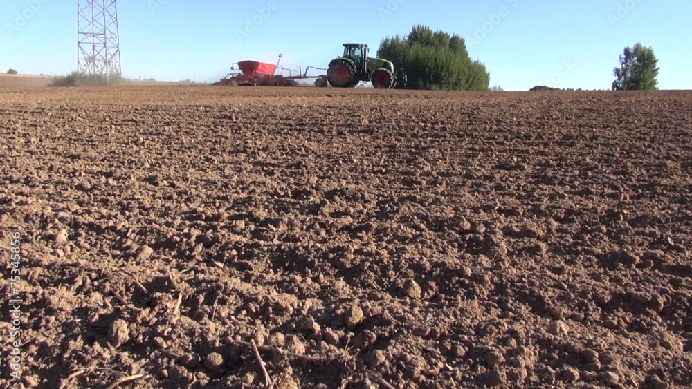 agriculture tractor on autumn farm field seeding grains agriculture tractor on autumn farm field seeding grains