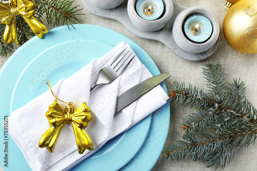 Christmas table setting in blue, golden and whitec olors photo