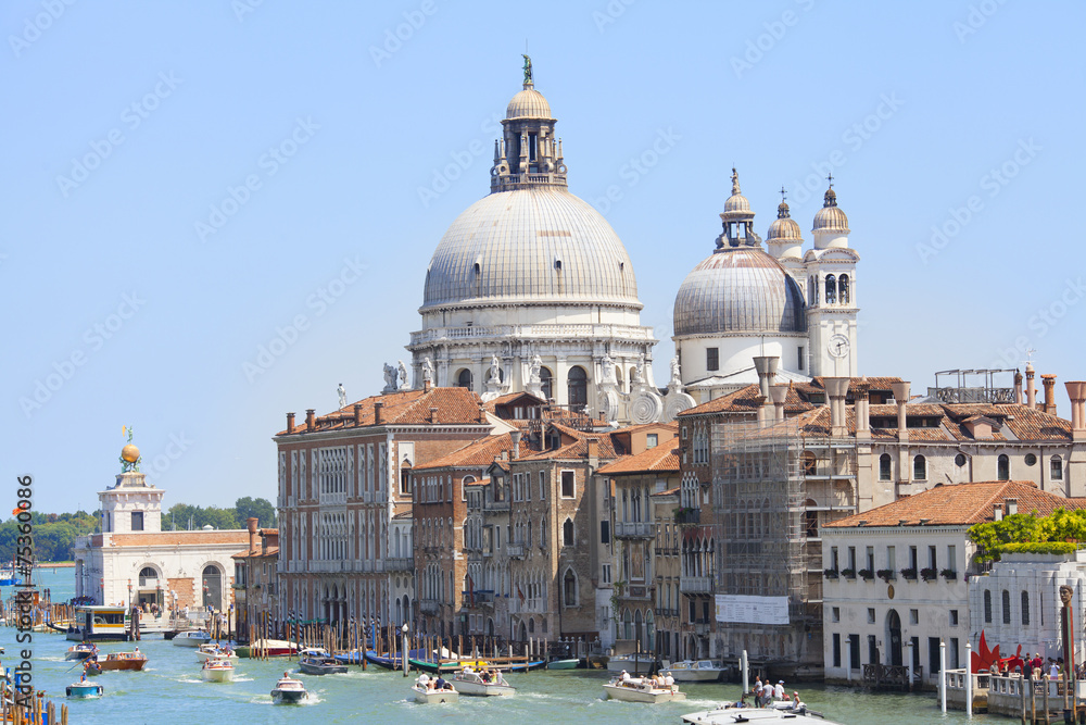 A view of the canal , boats and buildings in Venice