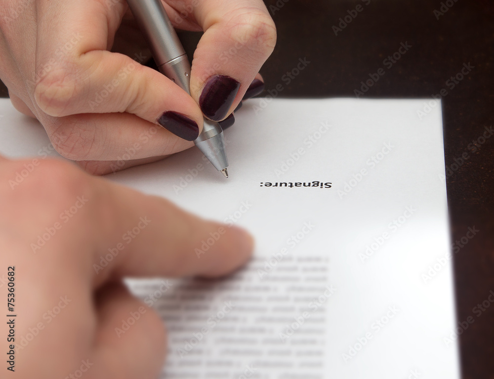 Hands of two people signed the document Hands of two people signed the document