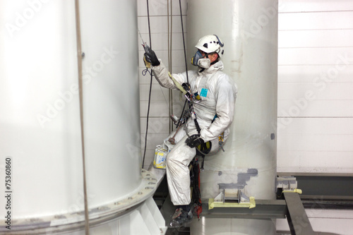 man painting with airbrush