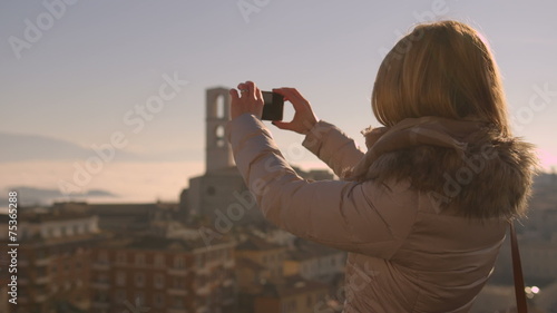 Girl takes a photo with digital smartphone