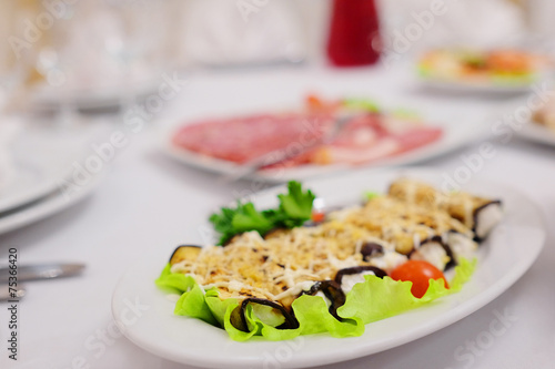 The image of the dishes and food on the served table