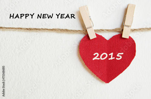 Red fabric heart with happy new year 2015 word background