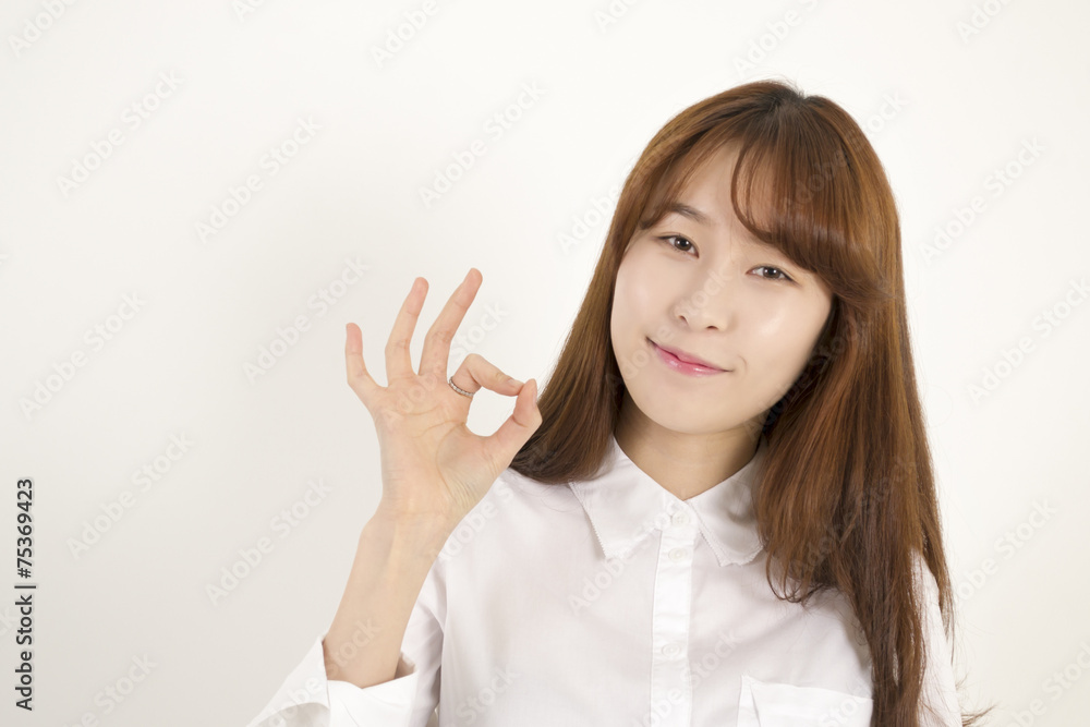Beautiful asian female student giving okay sign Beautiful asian female student giving okay sign