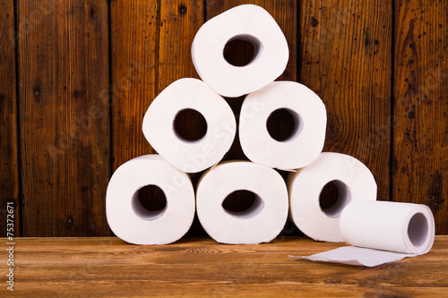 Toilet paper on a wooden table photo