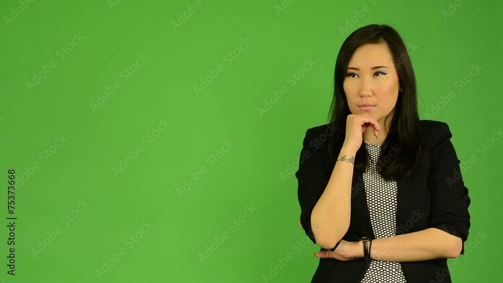 young attractive asian woman thinks - green screen young attractive asian woman thinks - green screen
