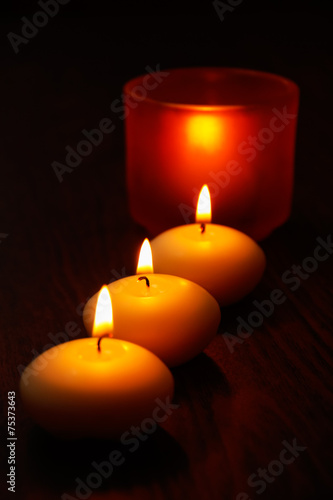 Glass candlestick and candles on wooden table