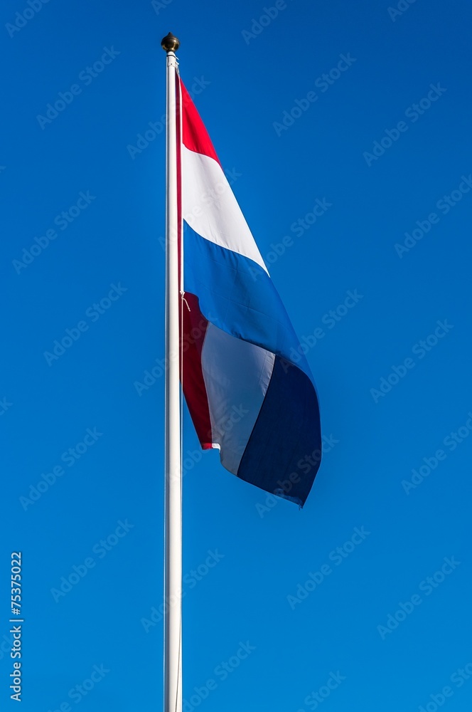 Netherlands flag on the blue sky