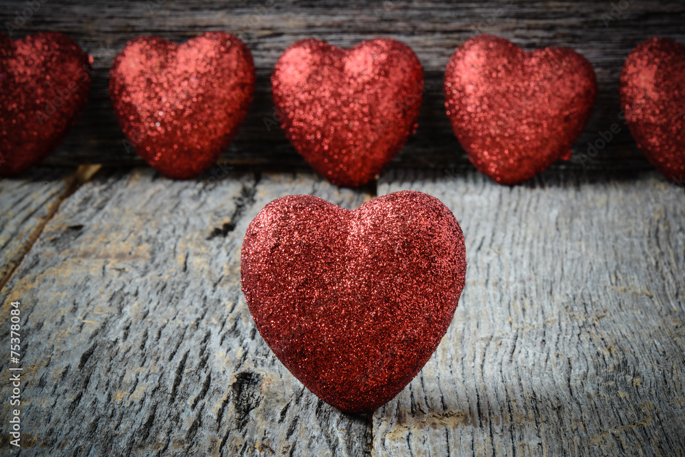 Obraz premium Hearts on Vintage Wood Background for Valentine's Day