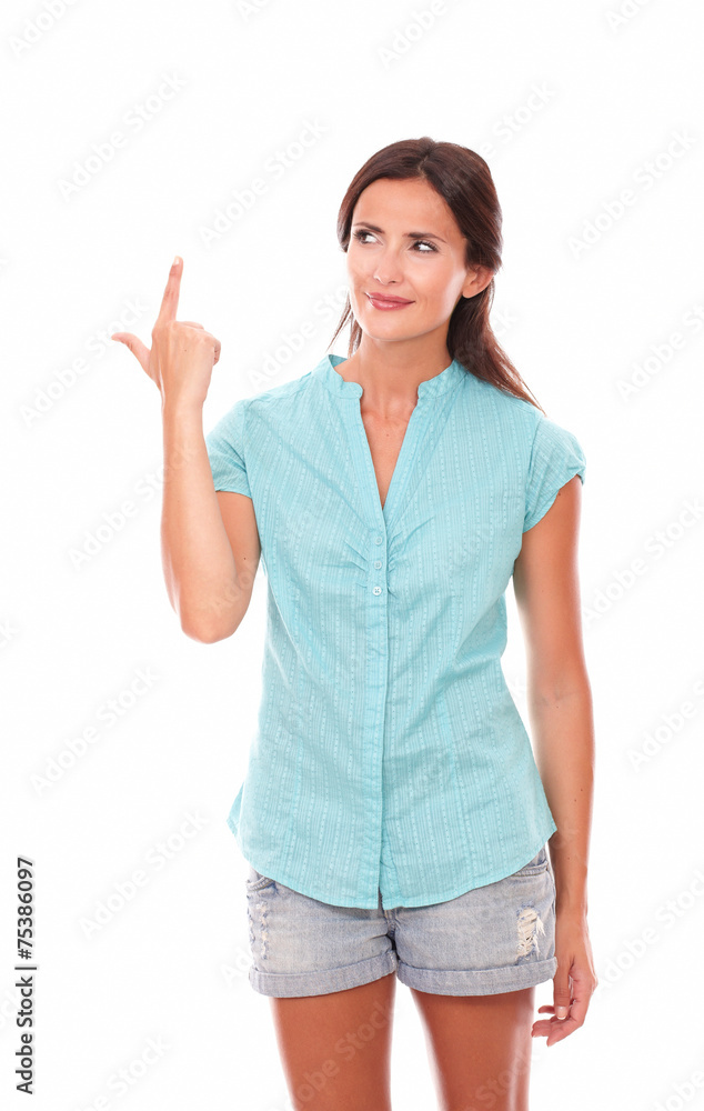 Lovely hispanic woman in blue blouse pointing up Lovely hispanic woman in blue blouse pointing up