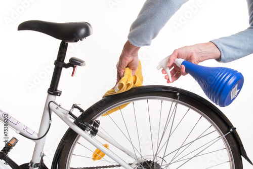 Hands with a cloth and water cleaning bicycle fender