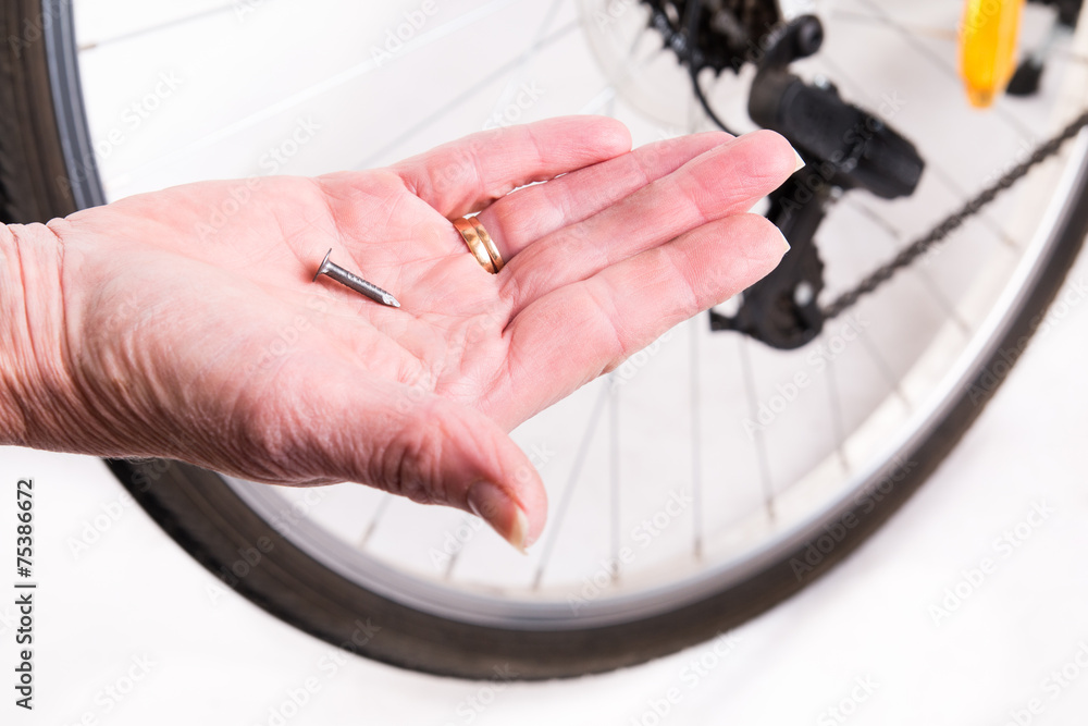 Nail punch a hole in the bike