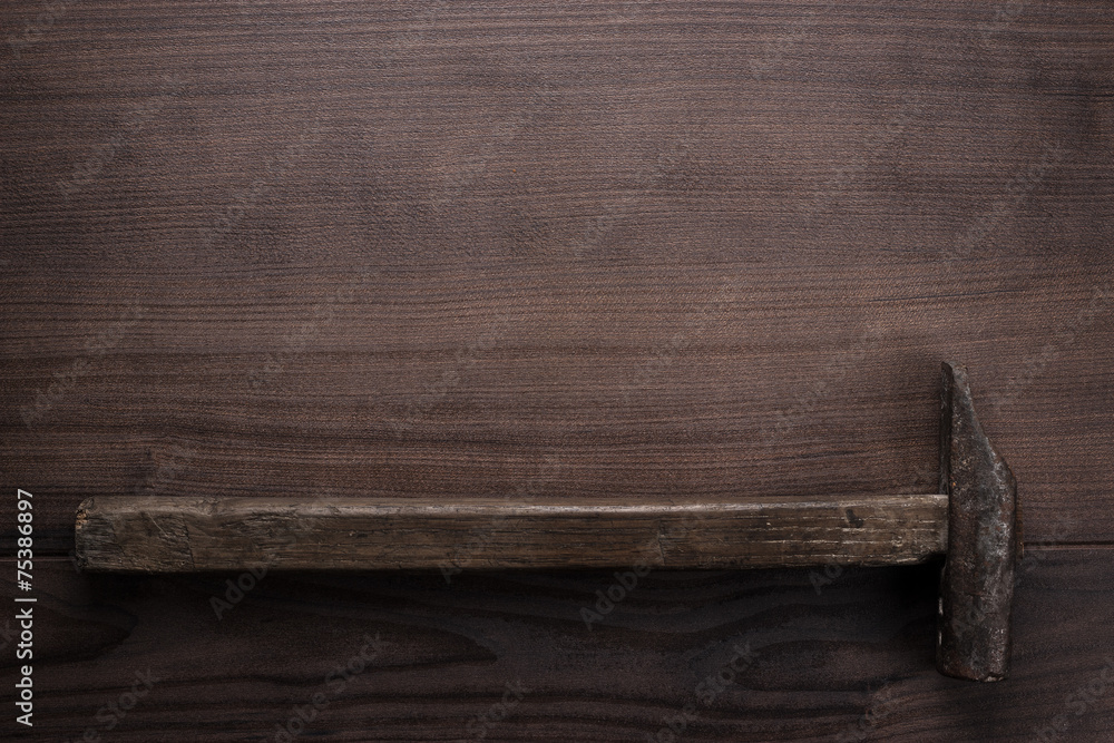 old rusty hammer on wooden background old rusty hammer on wooden background