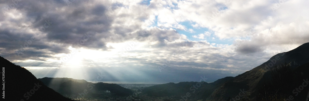 Tuscany Coast landscape panorama with sunrays through the clouds