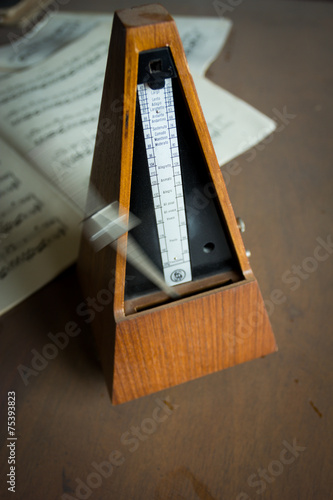 Wooden metronome sets the rhythm by swinging pendulum