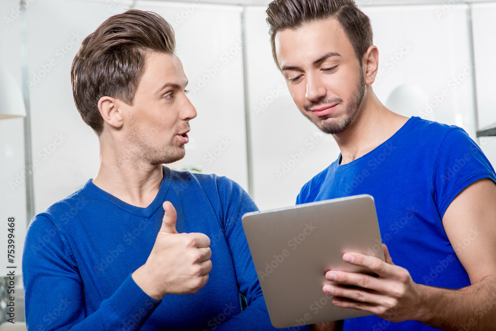 Brothers with digital tablet Brothers with digital tablet