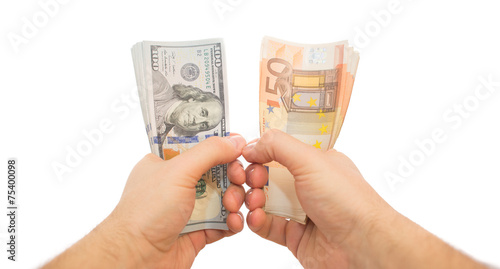 two hands holding dollars and euros isolated