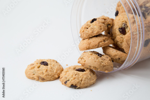 oatmeal raisin cookies spilling out of a jar