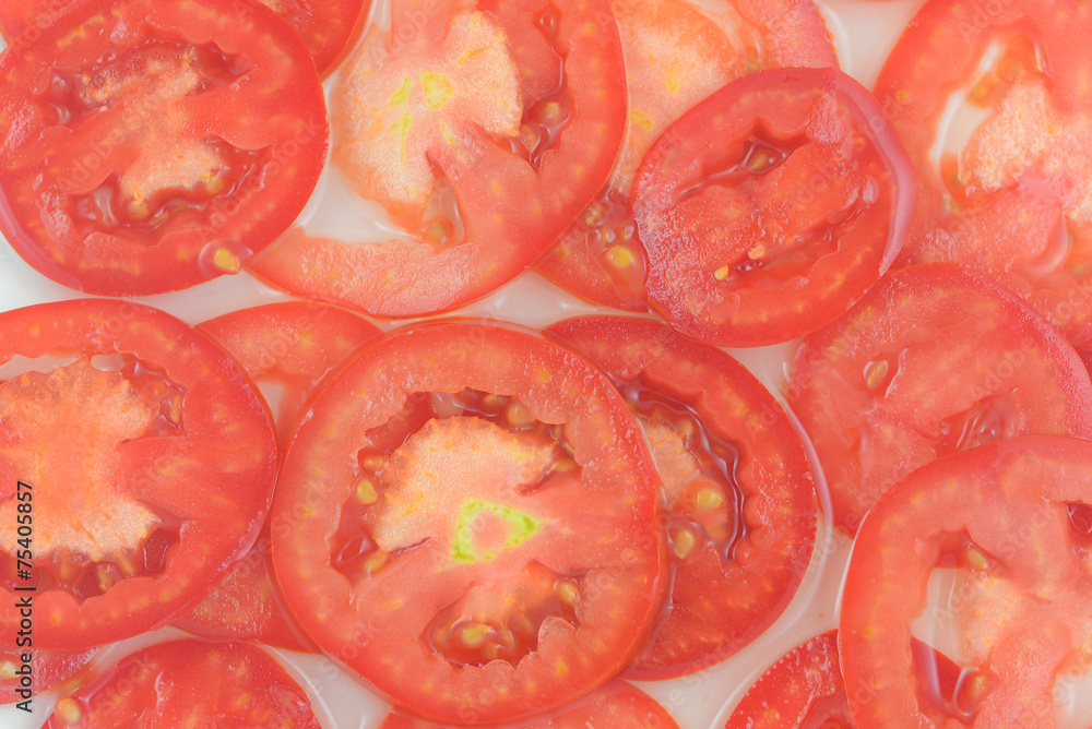 Tomato slices. Natural background with slices of tomato. Tomato slices. Natural background with slices of tomato.