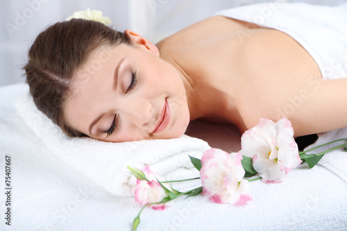 Beautiful young woman having relax in spa salon