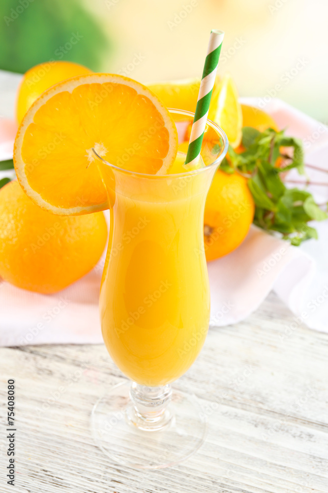 Glass of orange juice with straw and slices Glass of orange juice with straw and slices