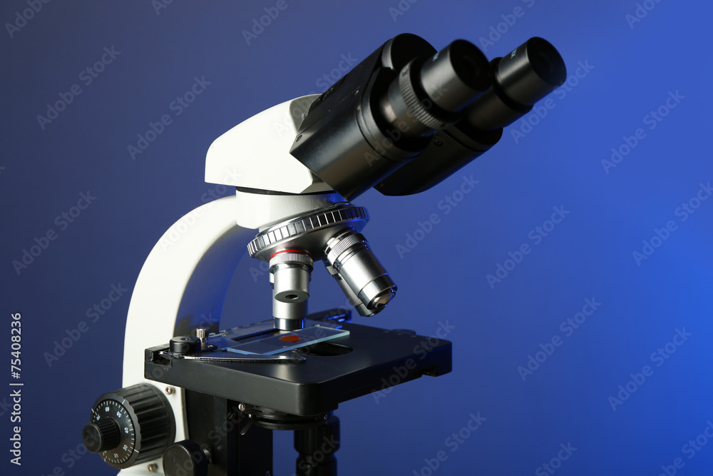 Microscope on table, on color background