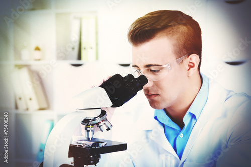 Young male researcher carrying out scientific research in lab