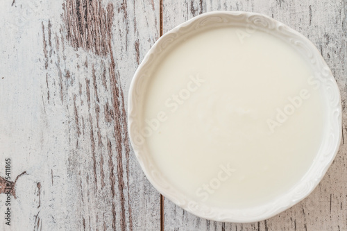 Plain Yogurt Served in a White Plate on White Wooden Table