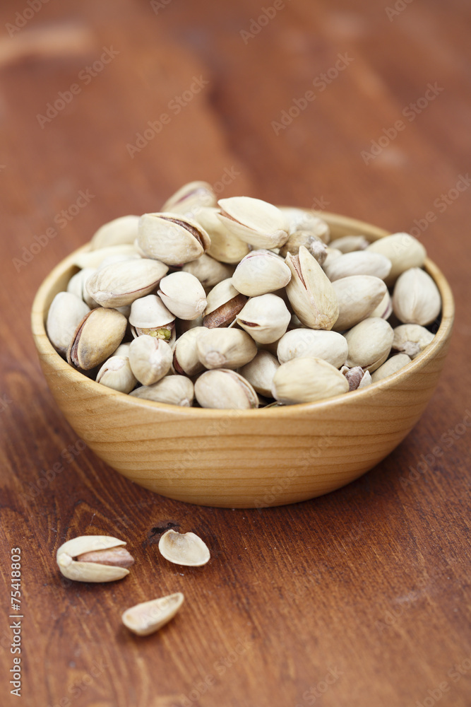 Pistachios in wooden bowl