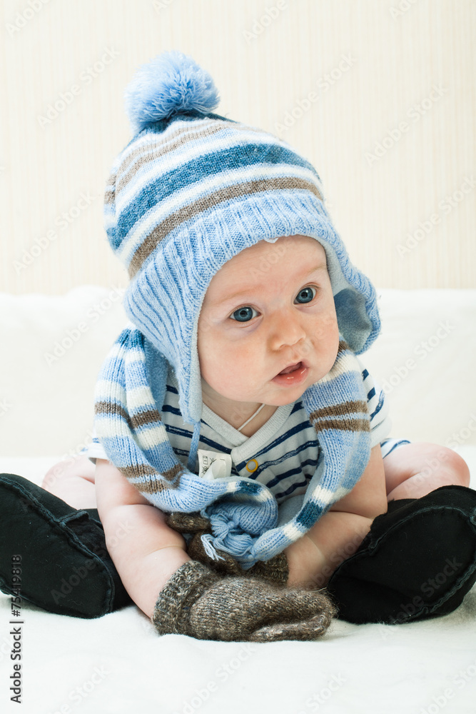 Cute baby boy wearing of warm knitted hat , gloves , Ugg boots Cute baby boy wearing of warm knitted hat , gloves , Ugg boots