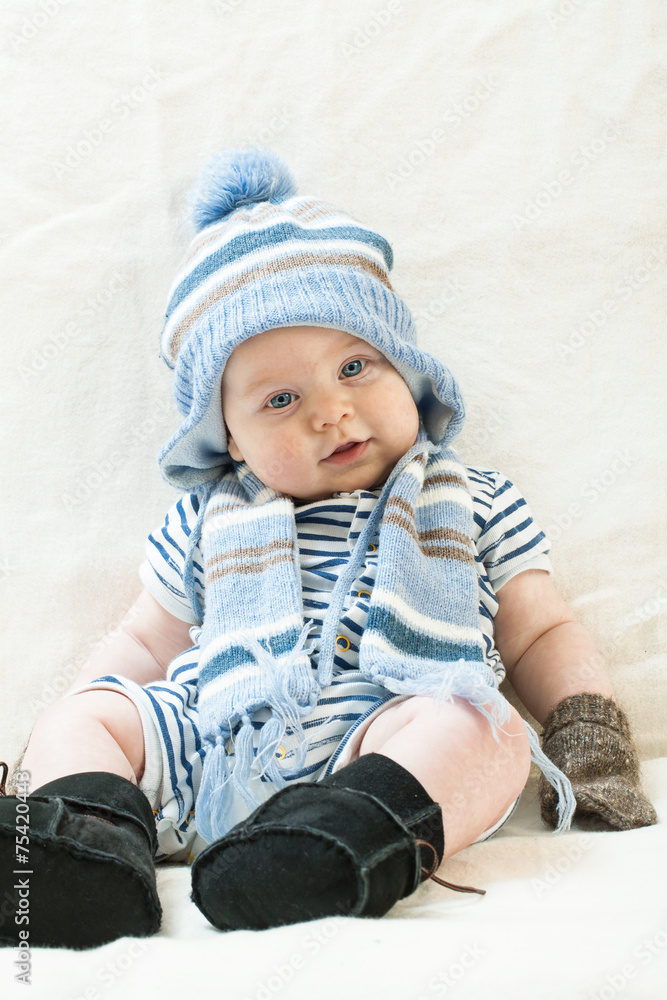 Cute baby boy wearing of warm knitted hat , gloves , Ugg boots Cute baby boy wearing of warm knitted hat , gloves , Ugg boots