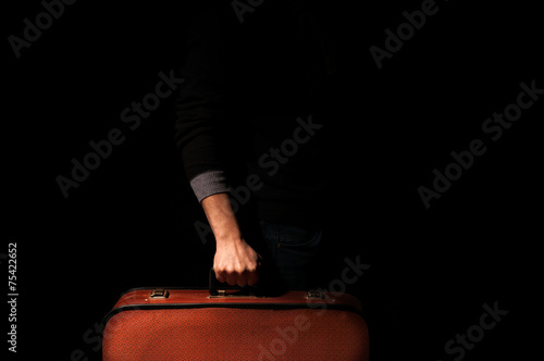 man holding a suitcase for a trip