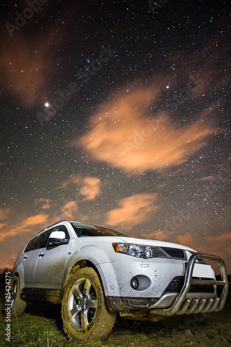 Muddy car with stars above