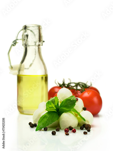 Oil , tomatoes, mozzarella and basil isolated on white