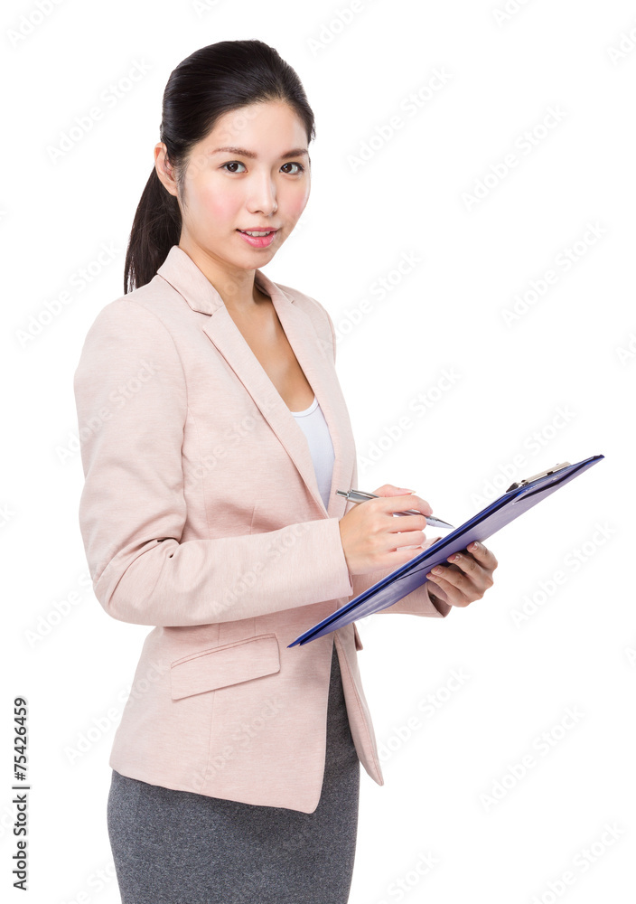 Businesswoman jot some note on clipboard
