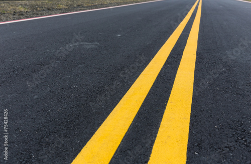 Asphalt road with pair of yellow line