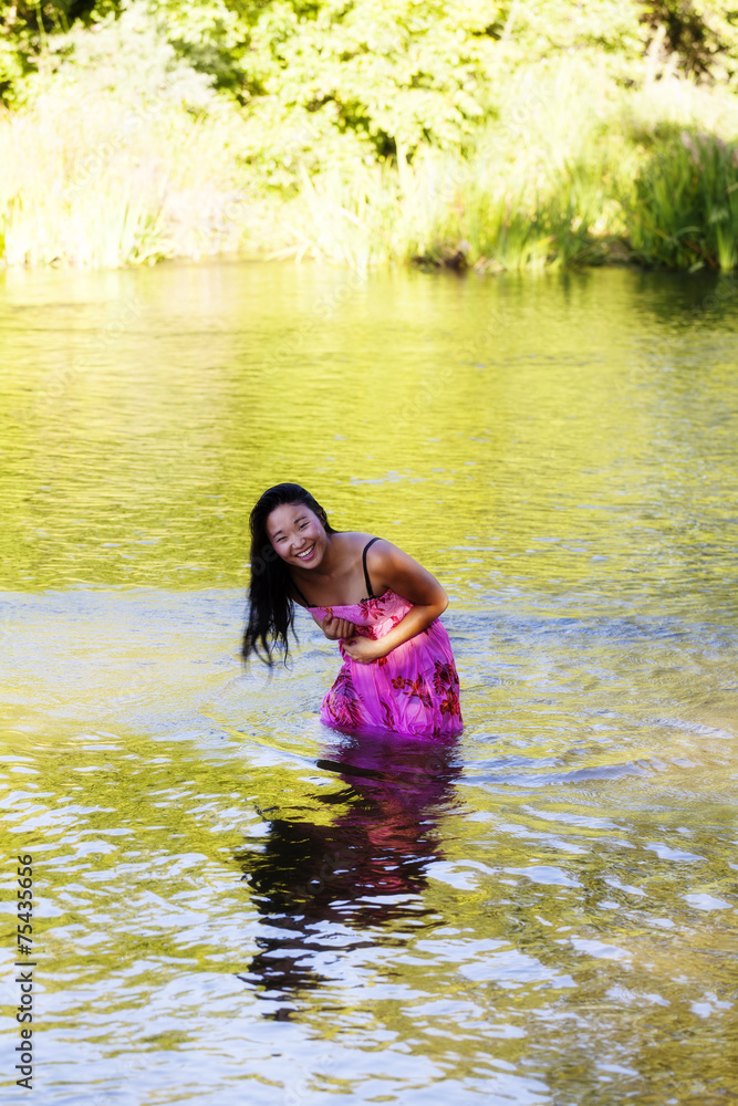 Fototapeta premium Smiling Wet Japanese Woman Wearing Dress In River